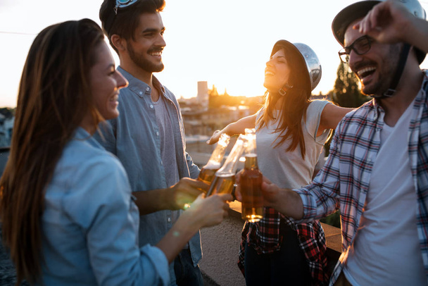 Group of happy young friends having party on rooftop - Photo, Image