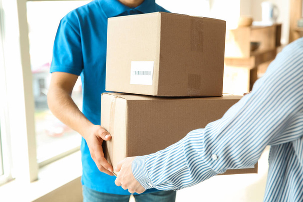 Woman receiving boxes from delivery man - Photo, Image