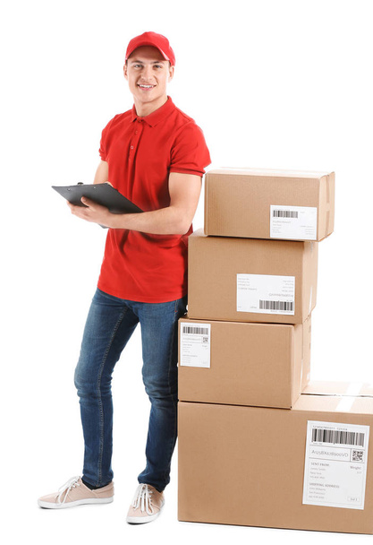 Delivery man with boxes and clipboard on white background - Photo, image