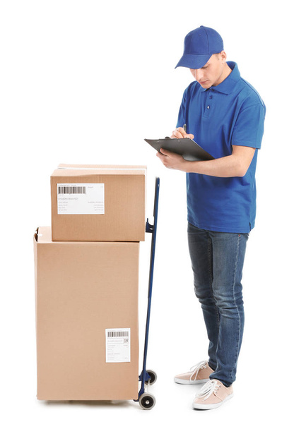 Delivery man with boxes and clipboard on white background - Photo, Image
