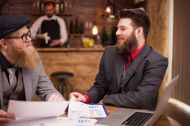Two bearded accoutants working from a vintage coffee shop - Photo, Image