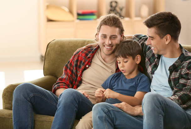 Happy gay couple with adopted child at home - Foto, afbeelding