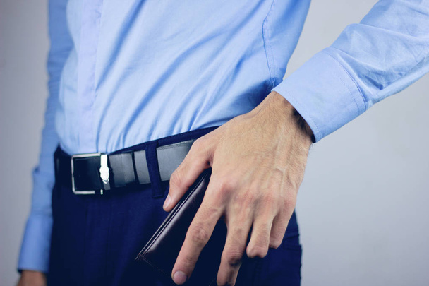 Businessman is taking his wallet out of the pocket - Photo, image