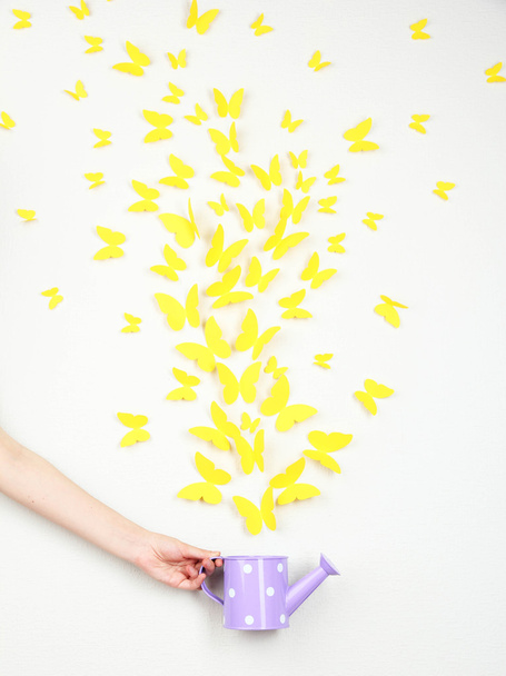 Paper yellow butterflies fly out of watering can - Foto, Imagem