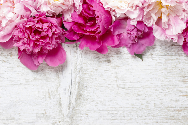 Stunning pink peonies on white rustic wooden background. Copy sp - Zdjęcie, obraz