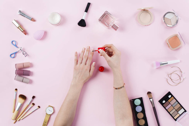 Make up products with woman doing nail polish - Fotoğraf, Görsel