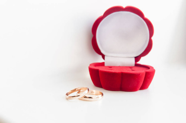 Beyaz bir arka plan üzerinde izole kırmızı kutu düğün iki altın yüzük - Fotoğraf, Görsel