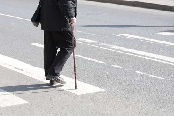 the disabled person walks in park on crutches - Fotó, kép