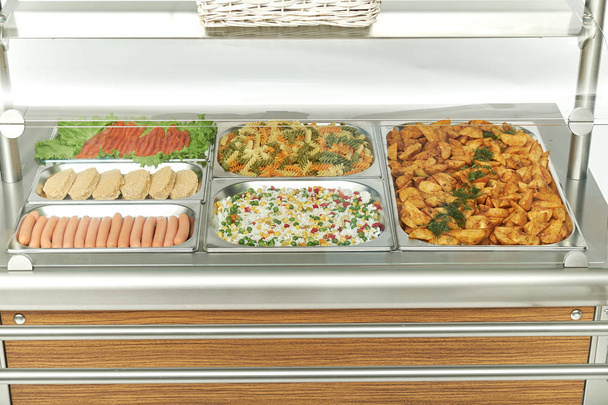 Showcase fridge for catering with cooked food - Foto, afbeelding
