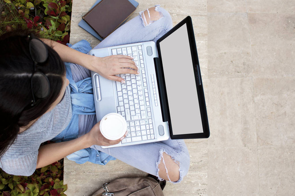 Young student female using laptop in outdoors. - Photo, Image