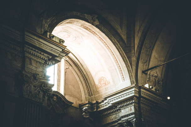 The light is shining through an window in an historic catholic c - Фото, изображение