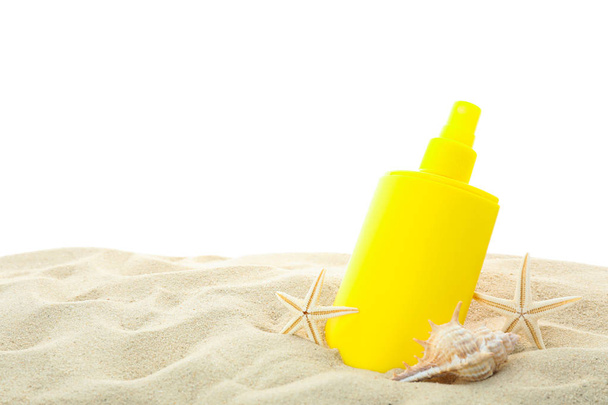 Sunscreen with starfish and seashells on clear sea sand isolated - Photo, Image