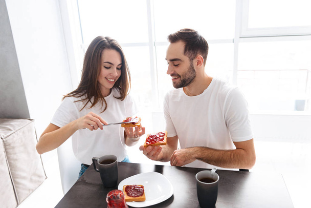 Happy young couple having breakfast together - Фото, зображення