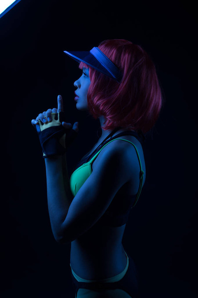 African-American woman in a sports image and a red wig. - Photo, Image