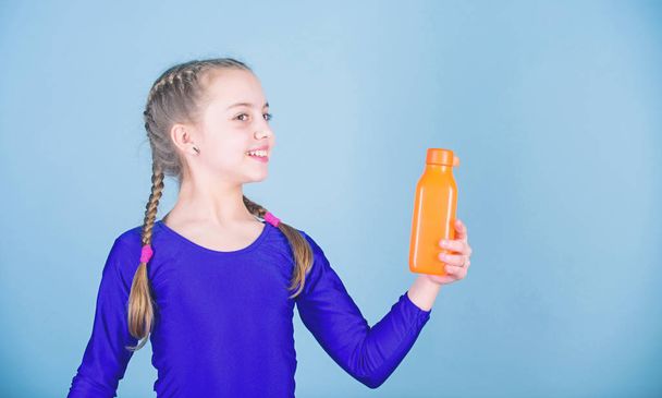 Water balance and hard gym training. Drink more water. Keep water bottle with you. Quench thirst. Child feel thirst after sport training. Kid cute girl gymnast sports leotard hold bottle for drink - Photo, image