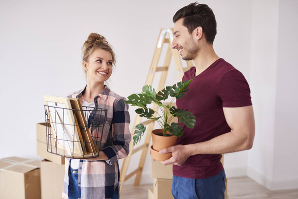 Young couple unpacking boxes of their stuff in new flat  - Photo, Image