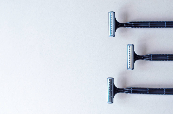 Three shaving machines on a light gray background. - Foto, Imagem
