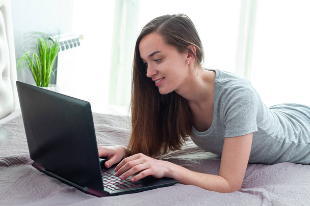 Young, single girl using laptop to chatting on social networks a - Zdjęcie, obraz