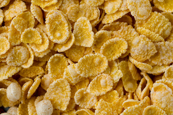 Texture of dry, frosted, glazed yellow corn flakes for cereals b - Valokuva, kuva
