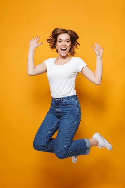 Full length portrait of a happy lovely girl jumping - Zdjęcie, obraz