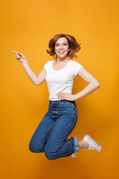 Full length portrait of a happy lovely girl jumping - Photo, Image