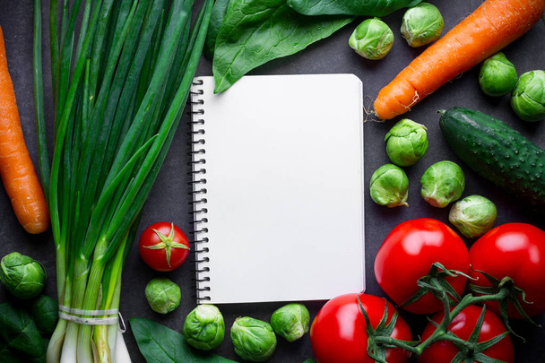 Ripe ingredients and blank recipe book for cooking fresh salad a - Fotó, kép