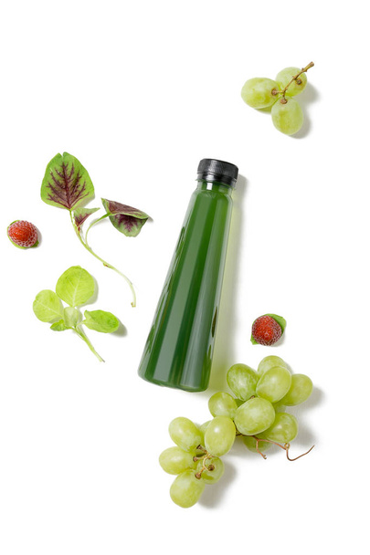 top view flat lay green bottle of juice with spinach, strawberries and grapes isolated on white background. Healthy lifestyle, vegetarian food concept. Detox  - Photo, image