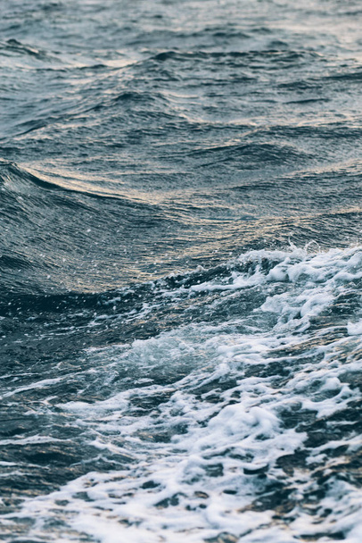ripples on blue sea water with white foam , natural sea background - Valokuva, kuva