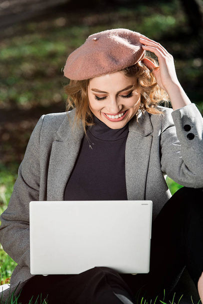 Преимущества работы на открытом воздухе. Образовательные технологии и интернет-концепция. Девушка работает с ноутбуком в парке, сидит на траве. Природный офис
. - Фото, изображение
