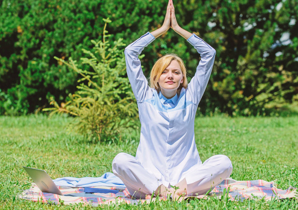Woman relaxing practicing meditation. Every day meditation. Reasons you should meditate every day. Find minute to relax. Clear your mind. Girl meditate on rug green grass meadow nature background - Фото, изображение