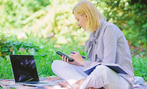 Guide starting freelance career. Become successful freelancer. Managing business outdoors. Woman with laptop sit grass meadow. Business lady freelance work outdoors. Freelance career concept - Fotó, kép