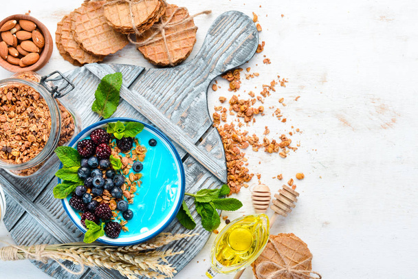 Blue Spirulina and Fresh Fruit Smoothie Bowl Topped with blackberries, blueberries, granola and yogurt. Breakfast. Top view. Free space for your text. - Фото, зображення