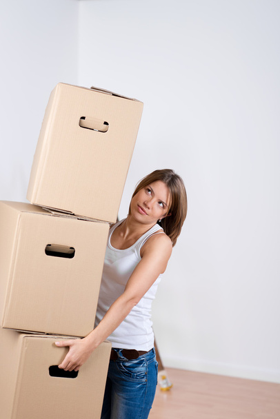 Woman carrying a stack of cardboard cartons - Foto, Imagem