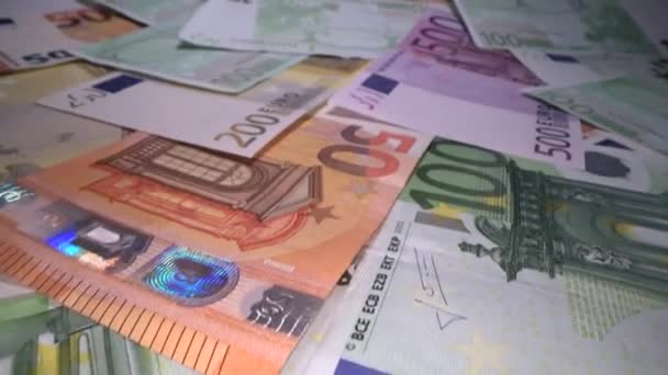 Dolly shot of euro bank notes background stacked on top of each other. Gliding through Euro money banknotes, pile of money, cash, stack of bills. Investing money, savings - Footage, Video