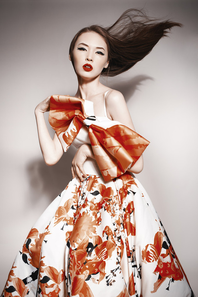 Young beautiful asian brunette in gorgeous Kravets dress, motion shot - Fotó, kép
