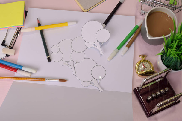 Bovenaanzicht van het snij papier illustratie een bomen op een roze tafel, voorbereiden om huiswerk te doen in een Klembord. Tekening Werkbureau concept - Foto, afbeelding