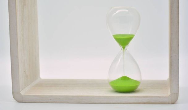 Green hourglass on white background - Foto, afbeelding