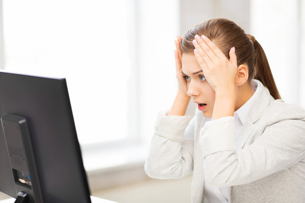 Stressed student with computer in office - Φωτογραφία, εικόνα