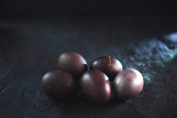 Dark purple eggs on a rough cement background - Foto, Bild