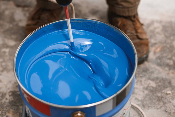 Bucket of blue paint mixing on motion - Photo, Image