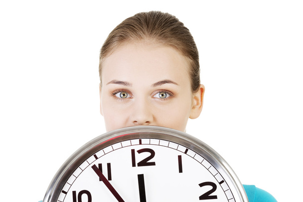 Happy young woman holding office clock - Foto, Imagem