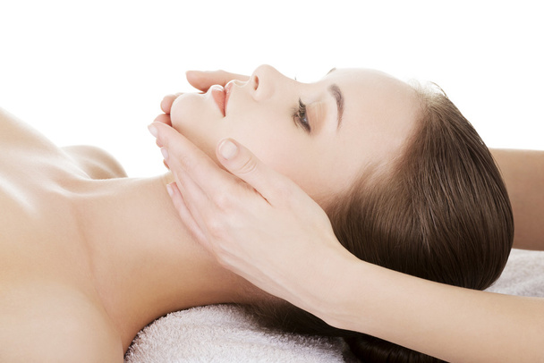 Relaxed woman enjoy receiving face massage at spa saloon - Foto, imagen
