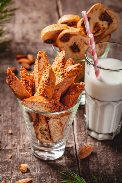 Biscotti or cantucci with milk on wooden rustic table. Close up. Christmas or New Year food concept - Photo, Image