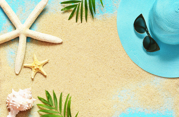 Tropical Background. Palm Trees Branches with starfish and seashell on sandy background. Travel. Copy space. - Photo, Image