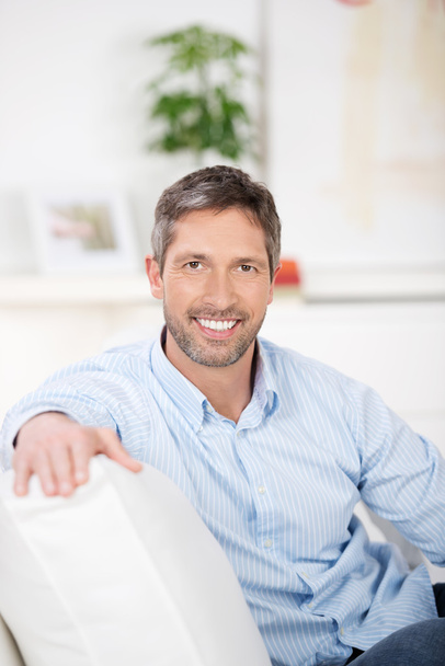 Smiling mature Man Sitting On Sofa - Foto, Imagen