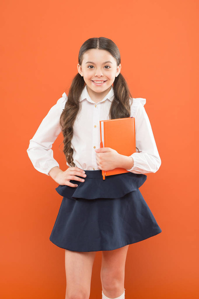 Inspiration for study. Back to school. Knowledge day. Possible everything. Schoolgirl enjoy study. Kid school uniform hold workbook. School lesson. Child doing homework. Your career path begins here - Фото, изображение