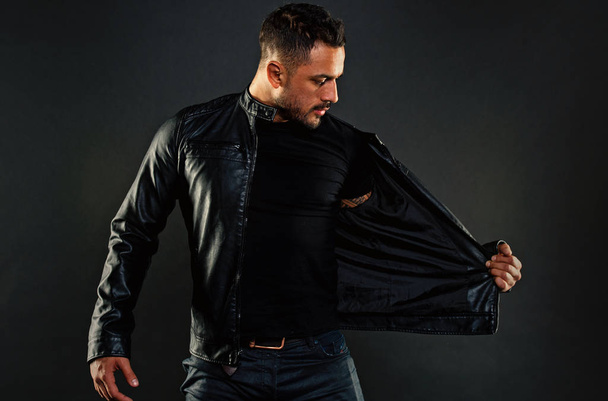 Bearded man undress leather jacket. Man with beard on unshaven face. Fashion model in casual style clothes. Style and trend. Mens sexuality or attraction and charisma - Foto, Bild