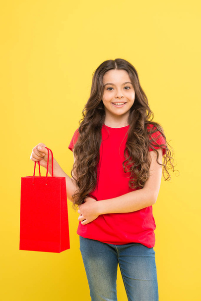 Rediscover great shopping tradition. Shopping and purchase. Black friday. Sale discount. Shopping day. Child hold package. Favorite kids brand. Girl with shopping bag. Save money. Live better - Zdjęcie, obraz