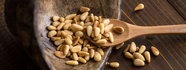 Pine Nuts on Dark Wooden Table. Toasted Organic Healthy Food. - Foto, Bild