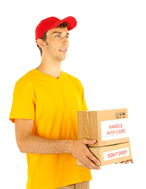 Young delivery man holding parcels, isolated on white - Foto, afbeelding
